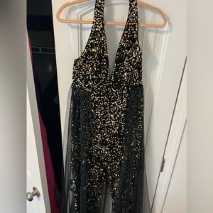 Black with gold sequin halter style jumpsuit size M. Never worn only tired on.